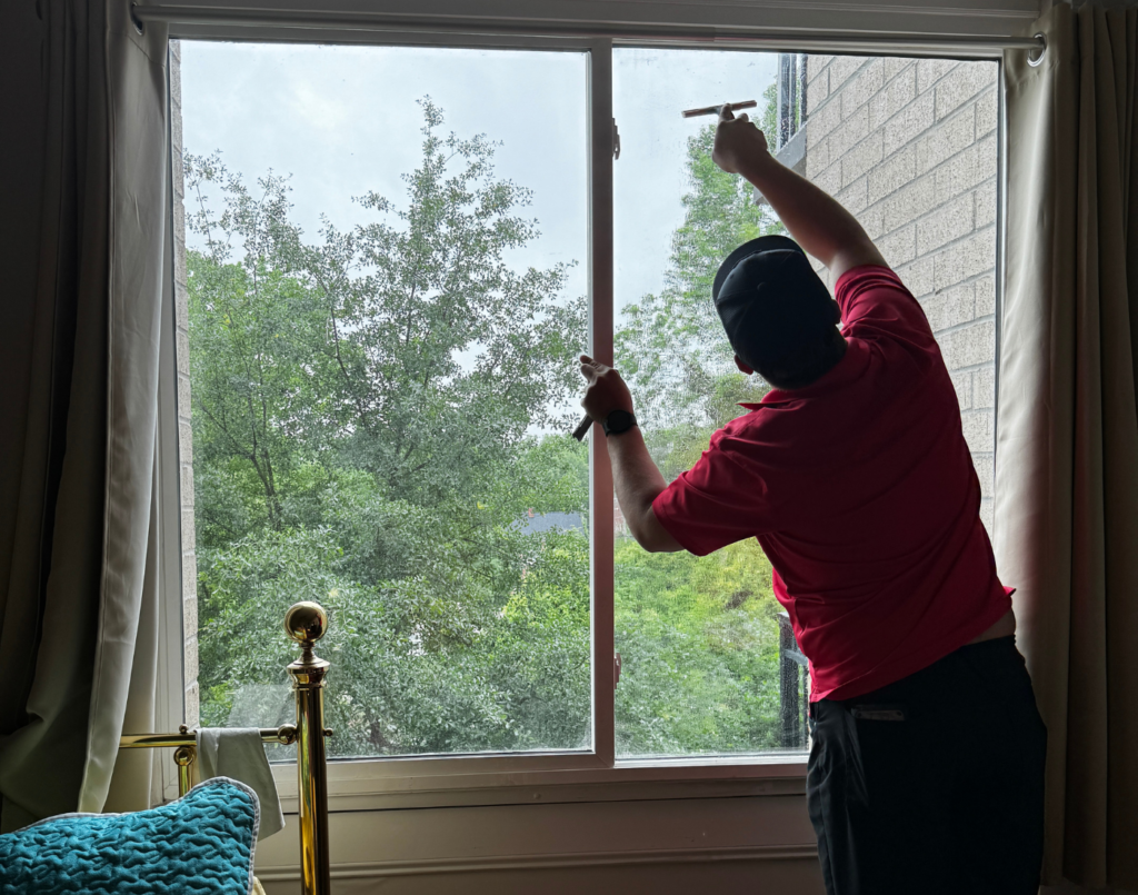 Sun Shades and Graphics technician applying residential window tinting.